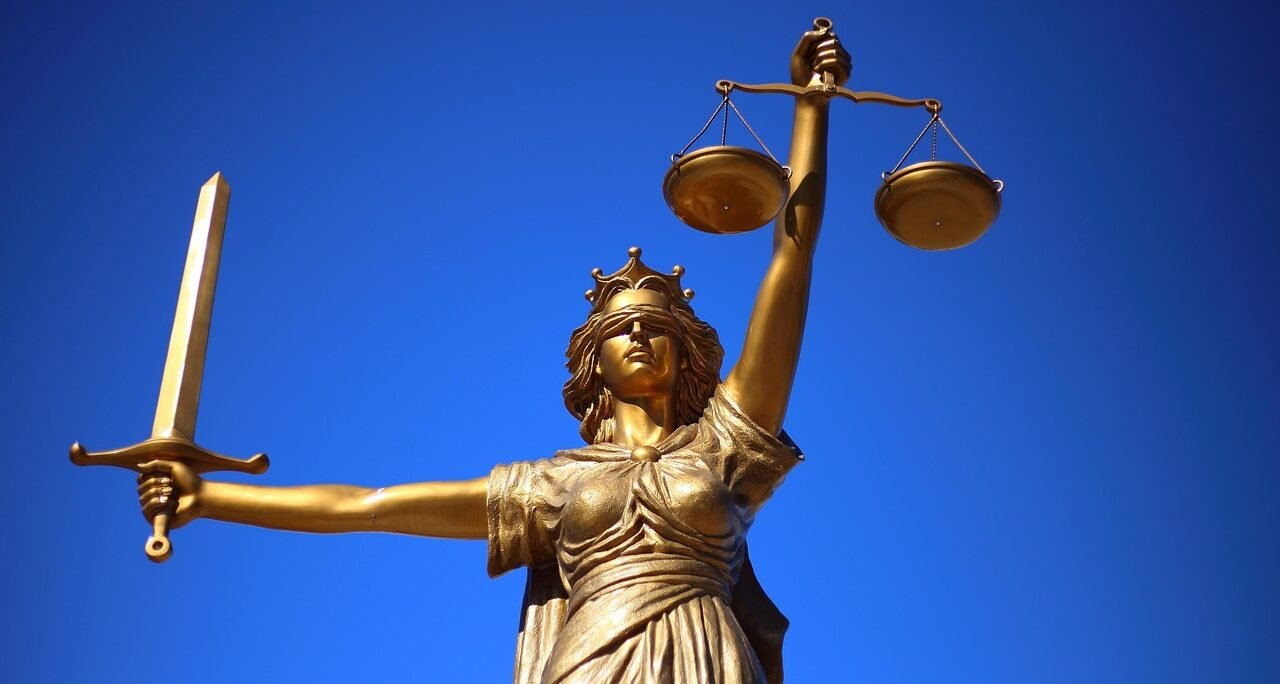A statue of Lady Justice holding scales, representing India's human rights complaint and grievance-redressal system